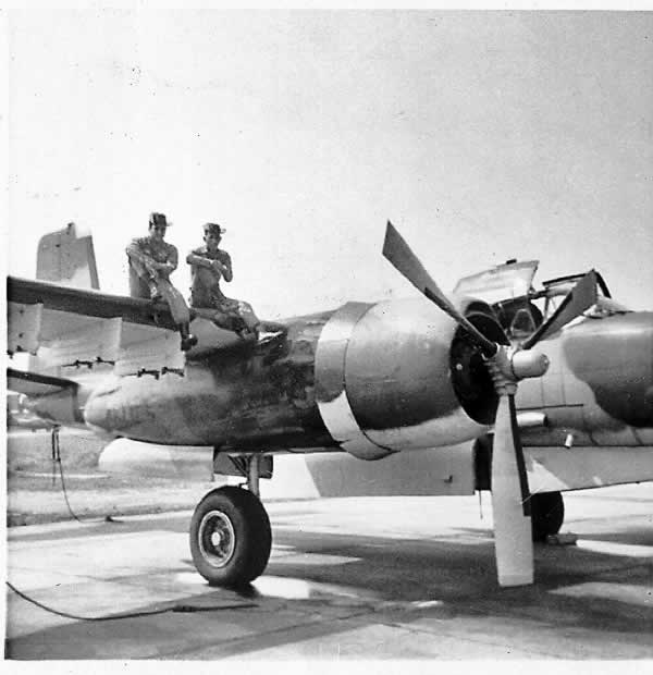 Air Commando SSgt Ed Flores (left) and a friend on the wing of an A-26 at England Air Force Base